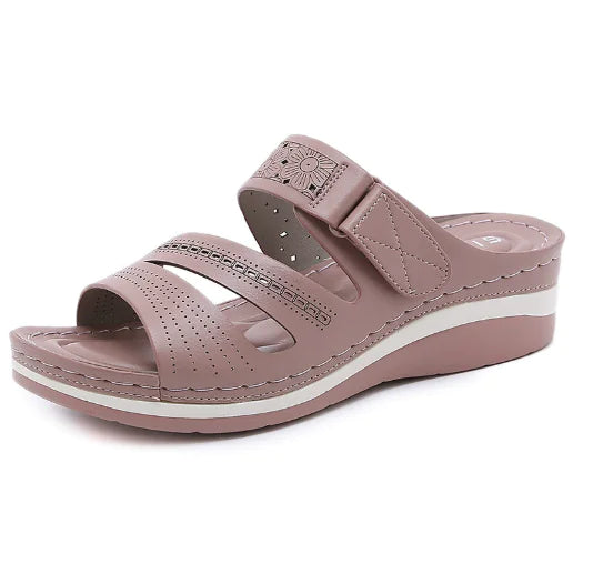 Pink sandal with a white sole on a white background