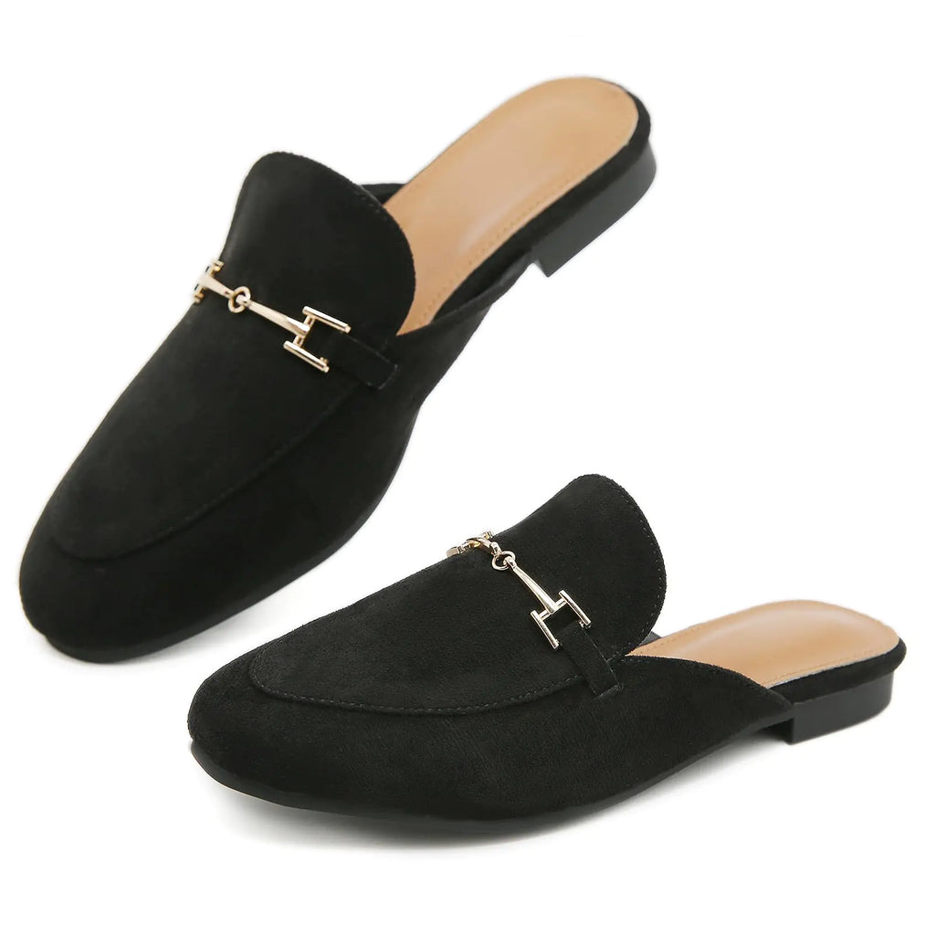 Black loafers with gold accents on a white background